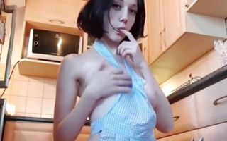 Horny Asian cutie is in the kitchen fucking her vagina with a dildo
